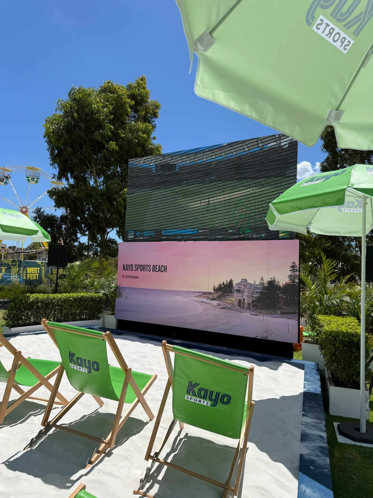 LED screen on a sand activation at Optus Stadium with branded deckchairs in full sun
